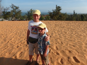 Boys at the red sand dunes