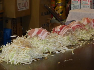 Cooking okonomiyaki with pork